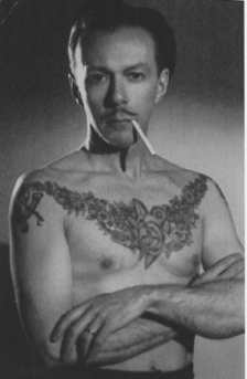 Phil Sparrow in photo with tattooed torso and cigarette in mouth